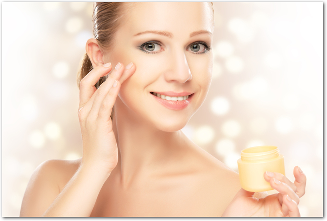 young beautiful woman using a face cream